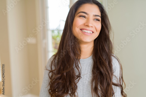Obraz na płótnie Beautiful brunette woman smiling cheerful, looking happy and positive
