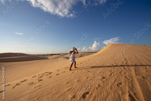 Portrait Young Asian Woman travel  On White Sand dune desert Muine  in Vietnam