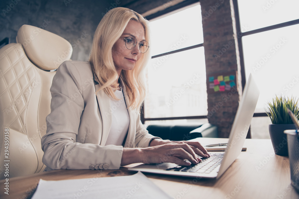 Low below angle view photo of concentrated programmer working on development of innovational software at office of her corporation Low below angle view photo of concentrated programmer working on development of innovational software at office of her corporation