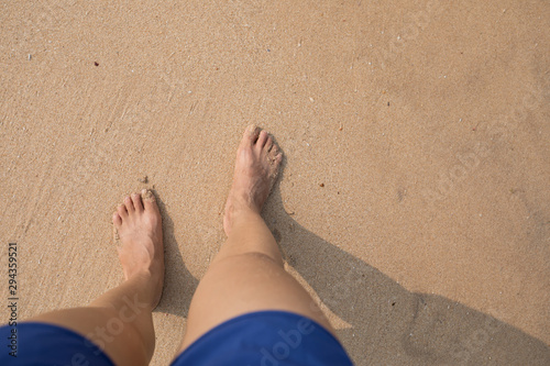 Closeup of legs stand on beach