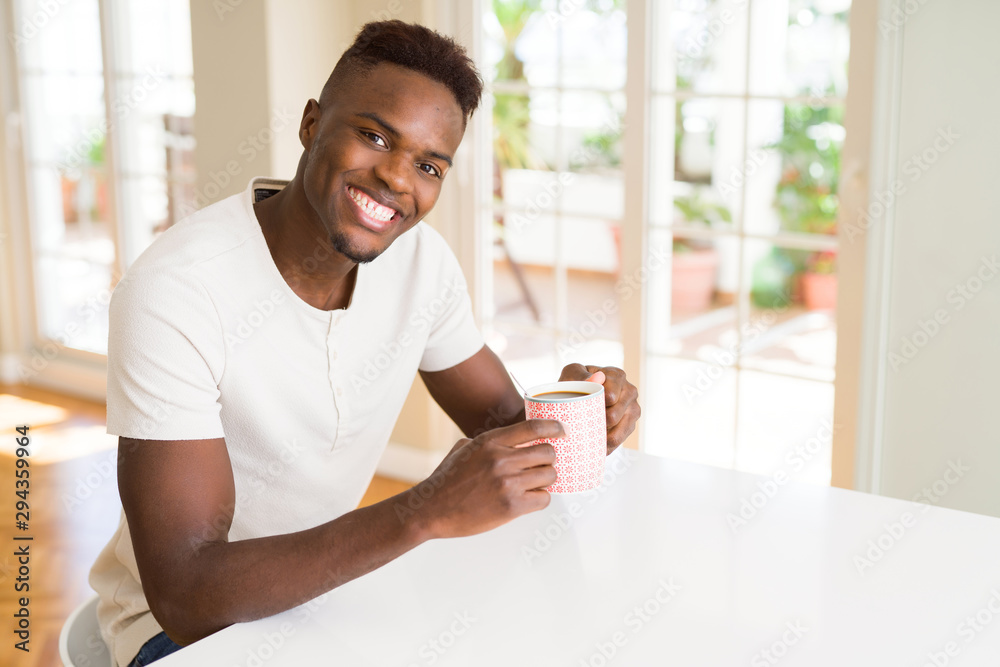 African american man smiling confident drinking a coffee at home African american man smiling confident drinking a coffee at home