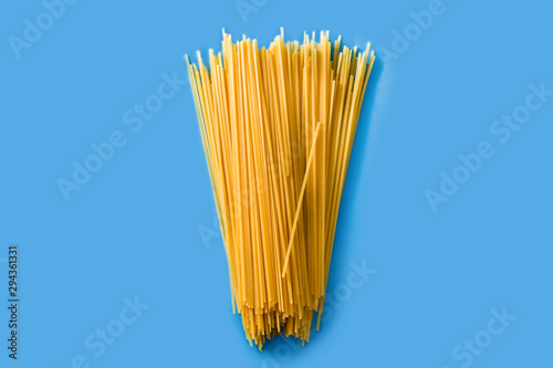 Raw Spaghetti pasta on blue background