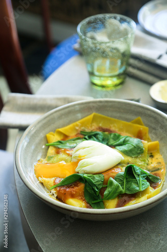 Homemade pasta with poached egg and spinach