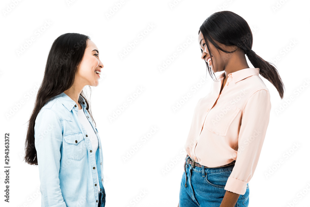 smiling asian and african american friends looking at each other isolated on white smiling asian and african american friends looking at each other isolated on white