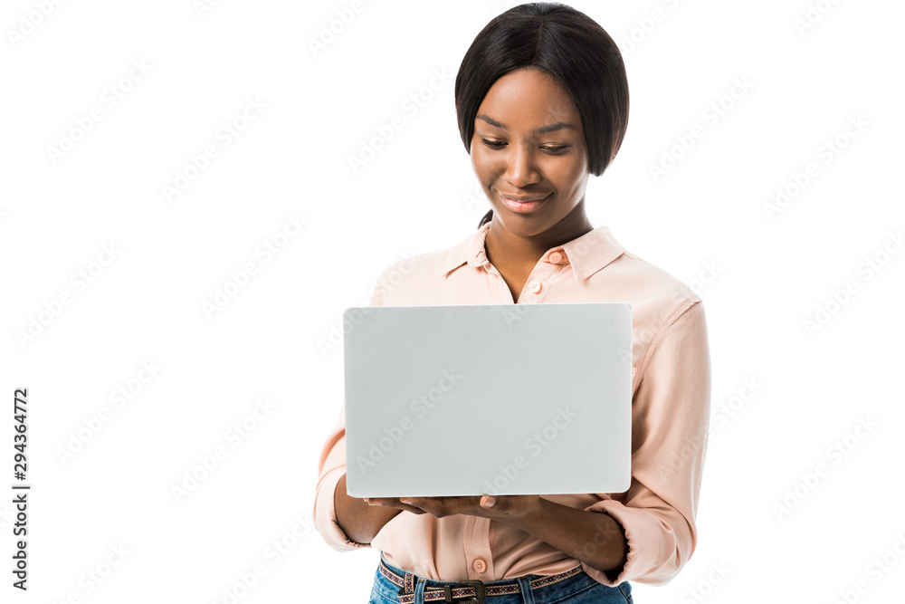 smiling african american woman in shirt using laptop isolated on white smiling african american woman in shirt using laptop isolated on white