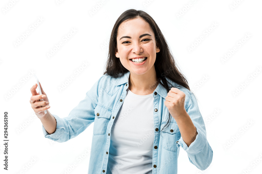 attractive asian woman in denim shirt showing yes gesture and holding smartphone isolated on white attractive asian woman in denim shirt showing yes gesture and holding smartphone isolated on white