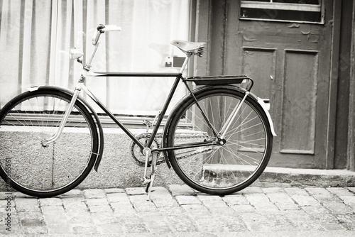 Greyscale image of a bicycle in a street