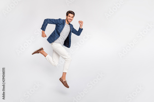Full length body size view of nice attractive luxurious cheerful cheery glad funny businessman wearing checked blazer jumping running fast movement motion isolated over light white pastel background