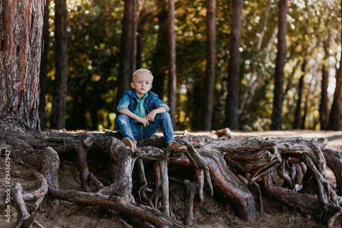 Portrait of a cute little boy of 3 years old outdoor in the autumn park
