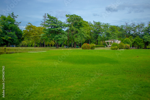 Green lawns and large trees provide shade for the people to relax