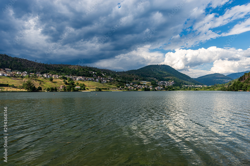Lake Serraia (Lago della Serraia) with the Alps and the small town of Baselga di Pine, Trento province, Trentino Alto Adige, Italy, Europe