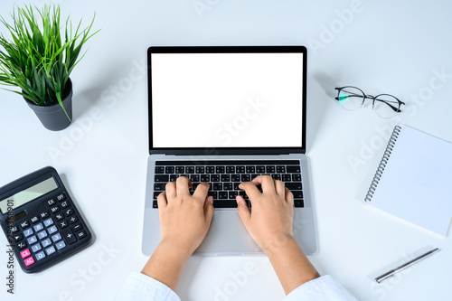 Businessman use laptop computer empty screen with clipping path on white table top. mockup business concept.