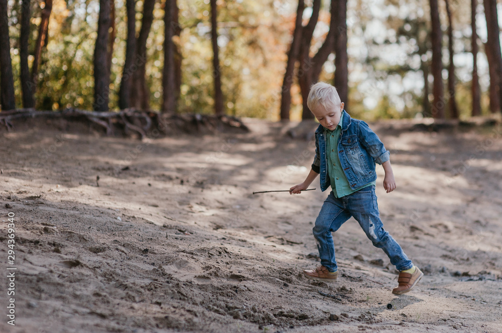 Emotional portrait of a happy and cheerful little boy, running after a friend laughing while playing on a walk in the park. Happy childhood. Summertime. Summer vacation. Positive emotions and energy Emotional portrait of a happy and cheerful little boy, running after a friend laughing while playing on a walk in the park. Happy childhood. Summertime. Summer vacation. Positive emotions and energy