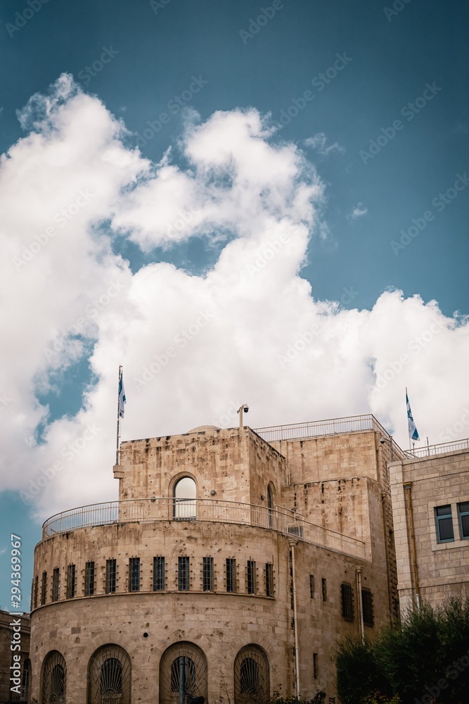 Jerusalem Historical City Hall Building, flags of Israel and cloudy sky