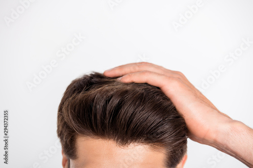 Cropped close-up photo of macho fix his haircut after anti dandruff therapy isolated over white background