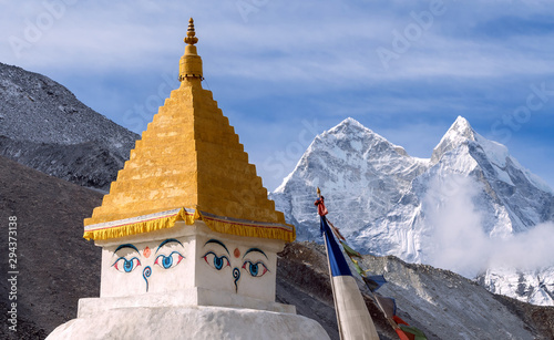 Buddhist Stupa and praying flags on the background of majestic Kangtega peak (6782 m) in Nepal, Himalayas photo