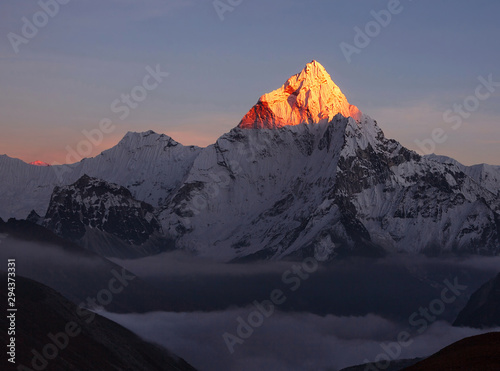 Last rays of sun at sunset mount; figuratively, the disappearance of hope, dissolution of all light in the dark, the victory of the forces of darkness over the forces of light. Ama Dablam peak (6856m)
