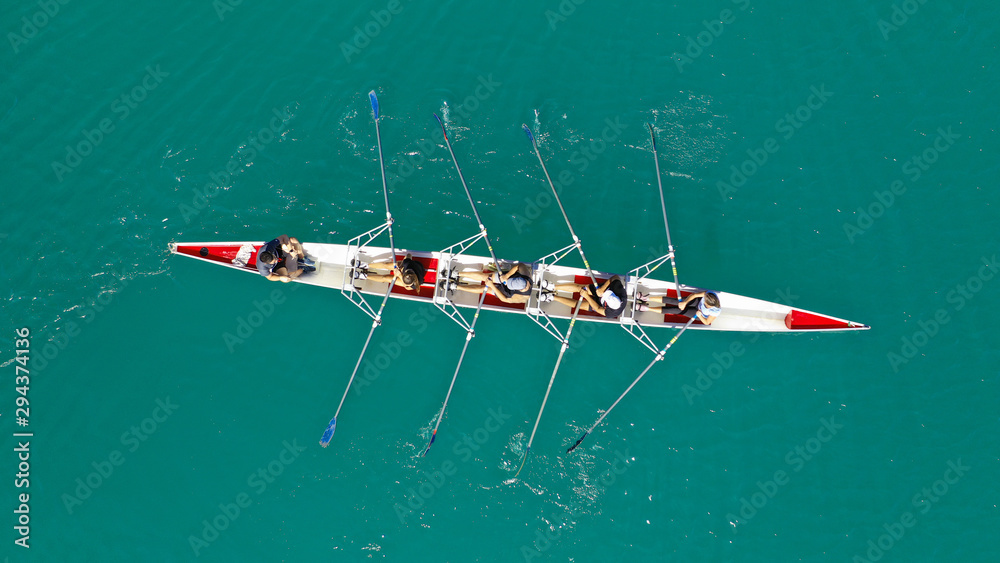 Foto de Aerial drone photo of team of Athletes rowing in sport canoe in ...