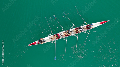 Obraz na płótnie Aerial drone photo of team of Athletes rowing in sport canoe in tropical exotic