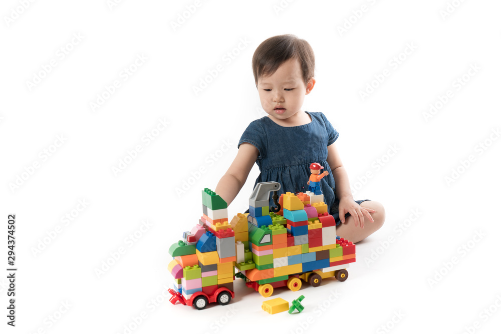 Smart Girls Combine Colored Building Blocks into a Truck Smart Girls Combine Colored Building Blocks into a Truck