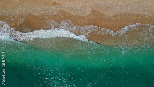 Aerial drone top down photo of tropical exotic sandy bay with emerald sea and waves