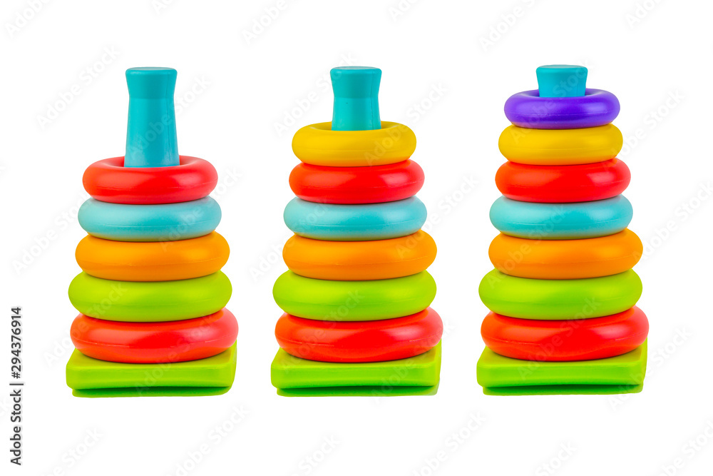 Plastic toy pyramid on a white background. Games and education concept Plastic toy pyramid on a white background. Games and education concept