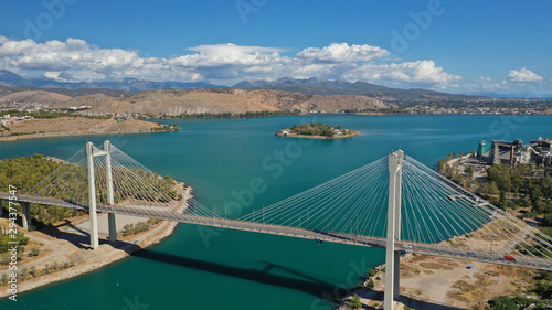 Aerial drone photo of famous new suspension bridge of halkida or Chalkida connecting mainland Greece with Evia island with beautiful clouds and blue sky, Greece © aerial-drone