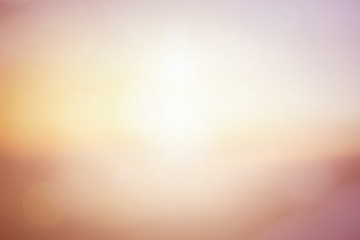 Natural background blurring warm colors and bright sun light. Bokeh or Christmas background Green Energy at sky sunny color orange light patterns plain abstract flare evening clouds blur.