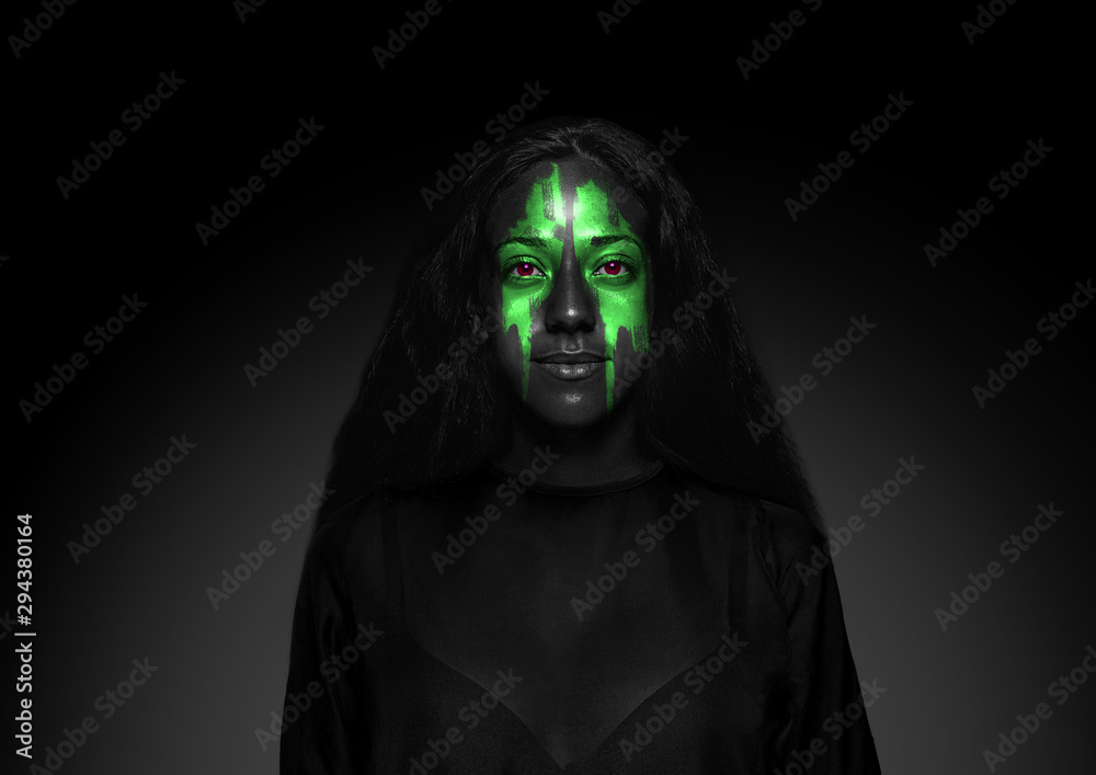 Discover what's inside you. Close up portrait of young woman isolated on black studio background. Bright neon light on the face. Halloween, scary look theme, october holidays, horror concept. Discover what's inside you. Close up portrait of young woman isolated on black studio background. Bright neon light on the face. Halloween, scary look theme, october holidays, horror concept.
