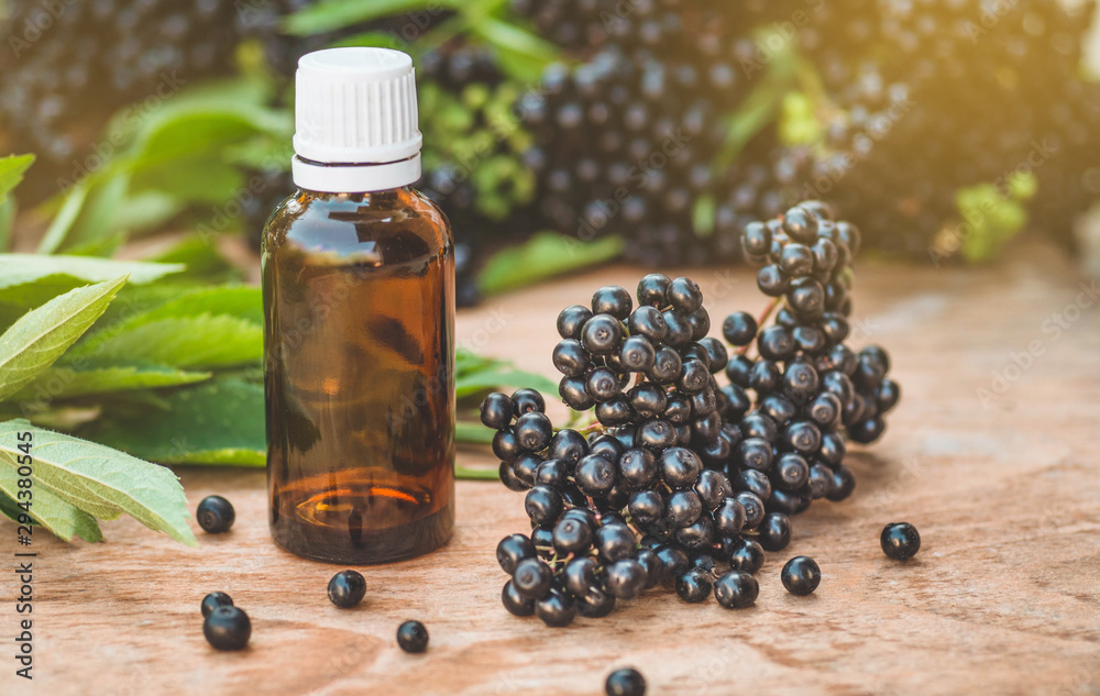 Elderberry syrup immunity boosting for flu season. Elder, black elder. European black elderberry background Elderberry syrup immunity boosting for flu season. Elder, black elder. European black elderberry background