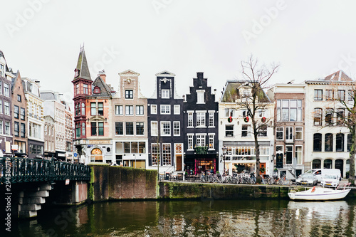 Cityscape in Amsterdam. Embankment and traditional buildings along the canal. © Ilona