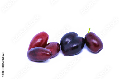 Cornus mas or Cornelian cherry fruit isolated on white background