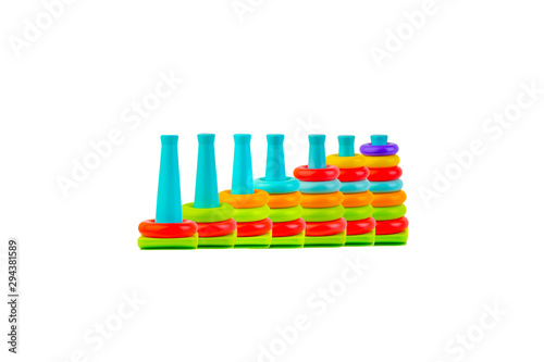 Plastic toy pyramid on a white background. Games and education concept