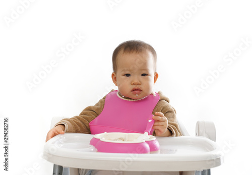 Mother feeds her baby with a spoon