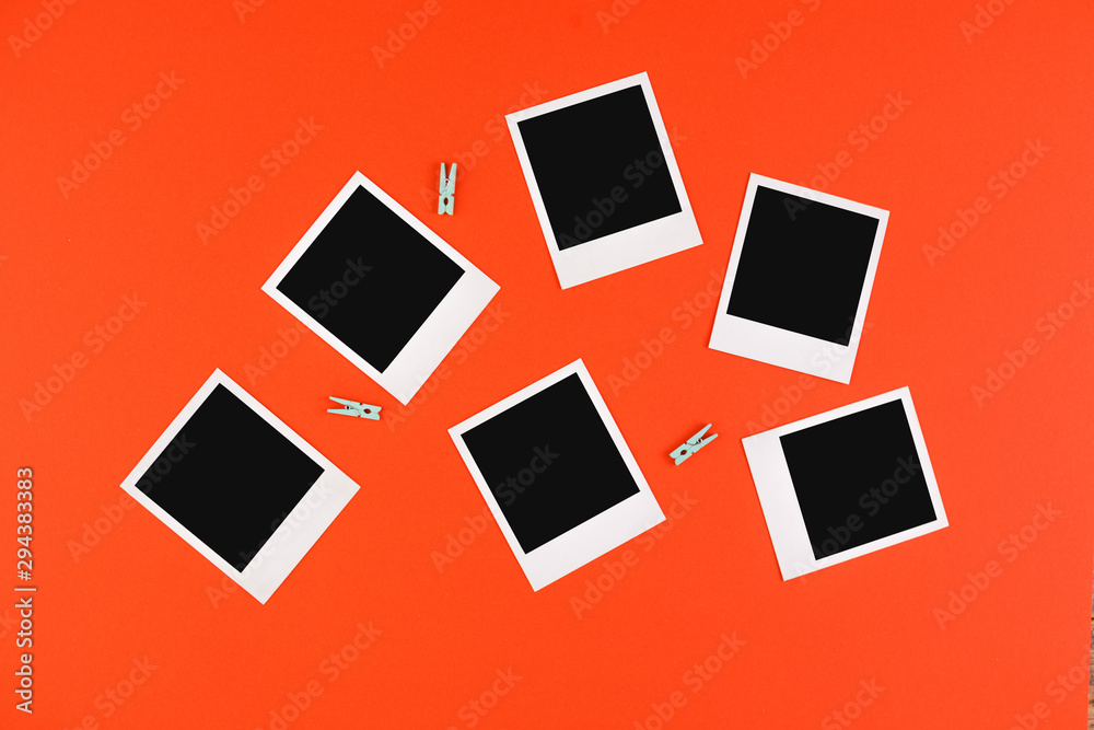 Instant photo frames and camera on a red background. Concept of preservation of memories. Flat lay. Instant photo frames and camera on a red background. Concept of preservation of memories. Flat lay.