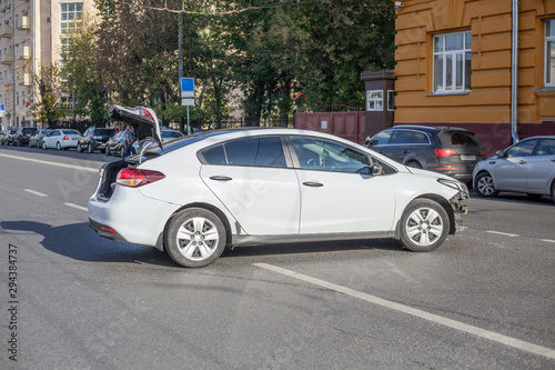White car had an accident. Accident on expensive in broad daylight. The car turned around from a blow. Dangerous situation on the road. © Олег Копьёв