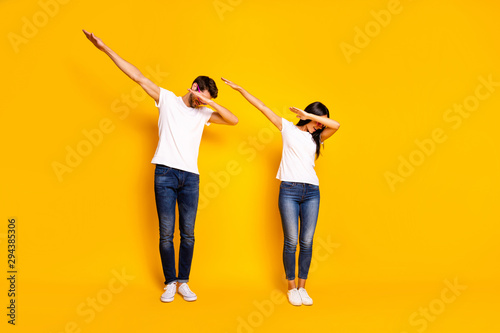 Full body photo of two people dancing at theme party cool modern moves wear casual clothes isolated yellow color background photo