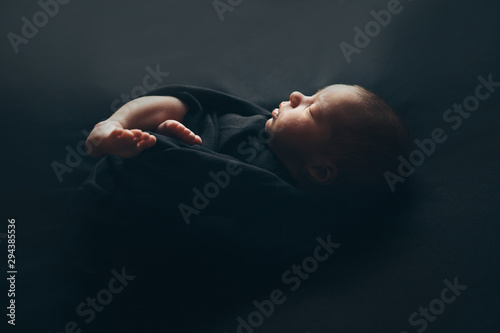 the concept of healthy lifestyle, IVF - a newborn baby sleeps under a blanket. Head, legs and arms