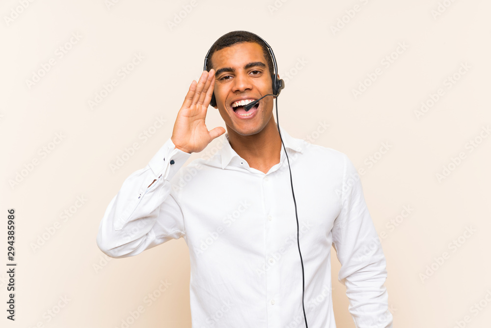 Young brunette man working with a headset shouting with mouth wide open Young brunette man working with a headset shouting with mouth wide open
