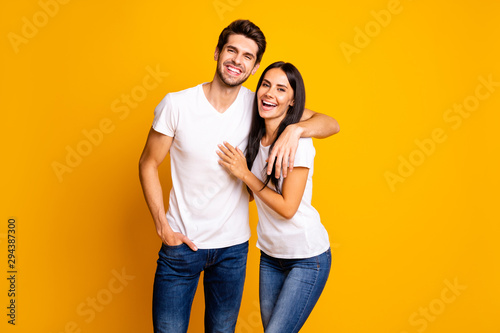 Photo of nice couple in love glad to see old friends talking different stuff wear casual clothes isolated yellow color background