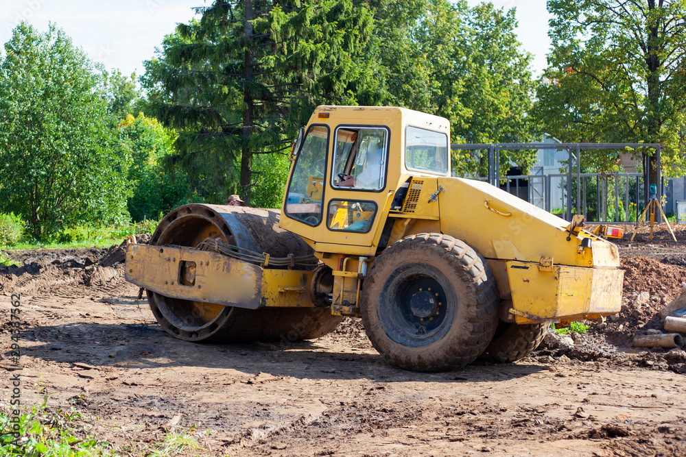 Bulldozer at a construction site. Heavy machinery performs construction work. A bulldozer levels the ground. The car is diesel powered. Bulldozer at a construction site. Heavy machinery performs construction work. A bulldozer levels the ground. The car is diesel powered.