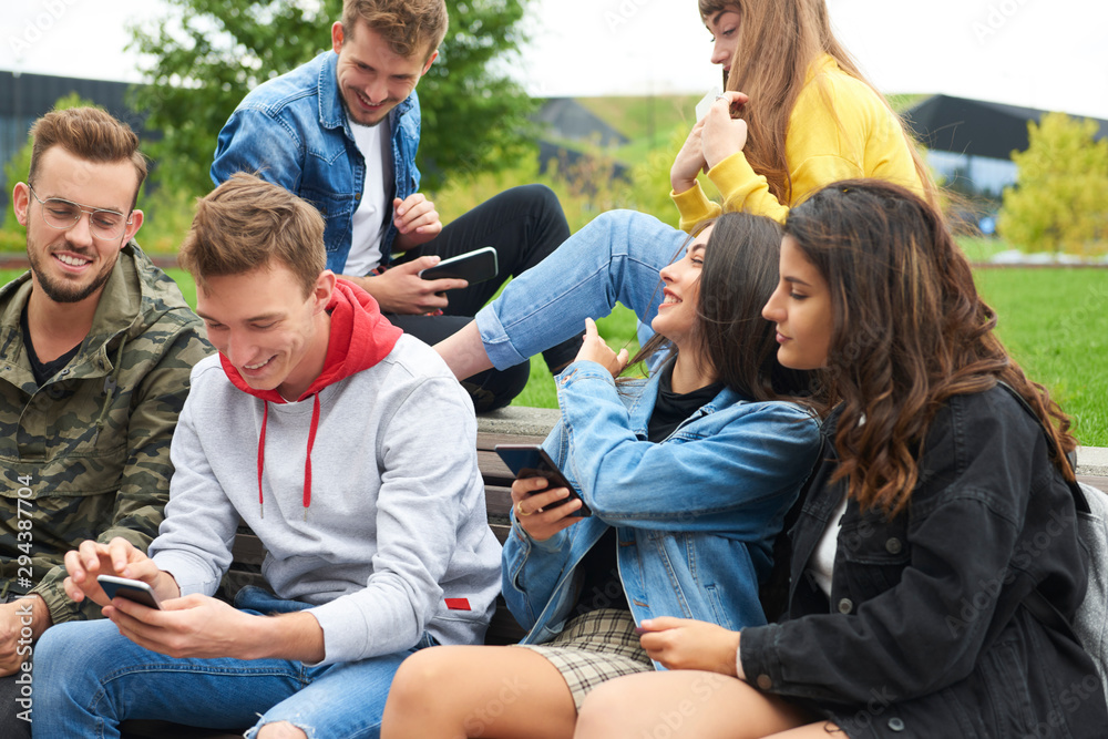 Group of young people using mobile phone Group of young people using mobile phone