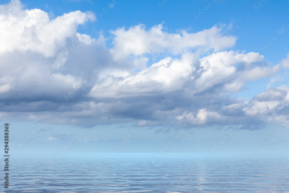 blue sky with white clouds over the sea