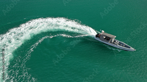Aerial top view luxury inflatable rib speed boat cruising in mediterranean emerald bay with crystal clear sea © aerial-drone