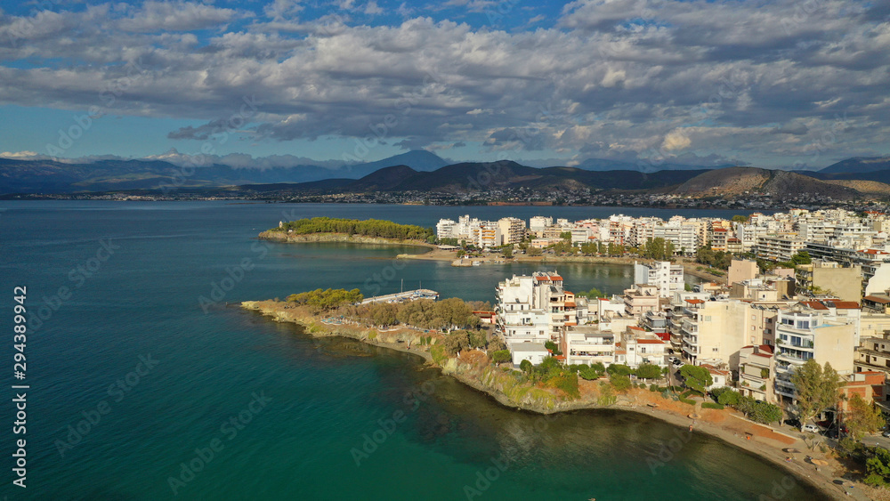 Aerial photo of famous seaside town of Halkida with beautiful clouds and deep blue sky, Evia island, Greece Aerial photo of famous seaside town of Halkida with beautiful clouds and deep blue sky, Evia island, Greece