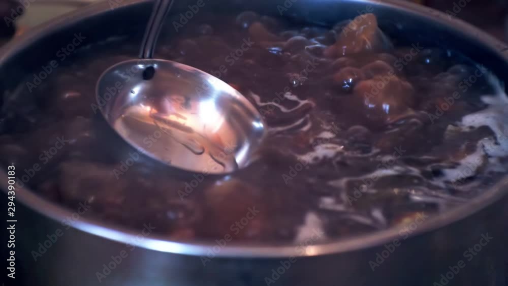 Delicious homemade soup is boiled in a large saucepan.close-up. Delicious homemade soup is boiled in a large saucepan.close-up.