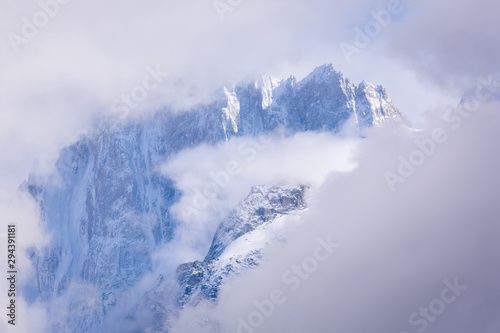 The top of the Alps Mont Blanc. Mountains in the clouds in the fog. Climate problems warming and lack of snow.