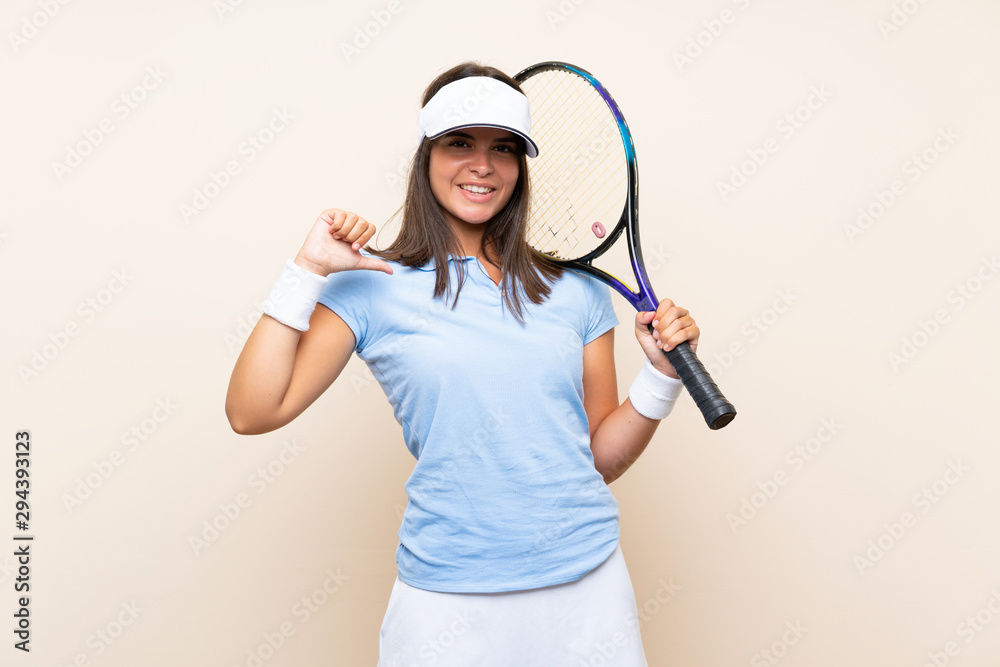 Young woman playing tennis over isolated background proud and self-satisfied Young woman playing tennis over isolated background proud and self-satisfied