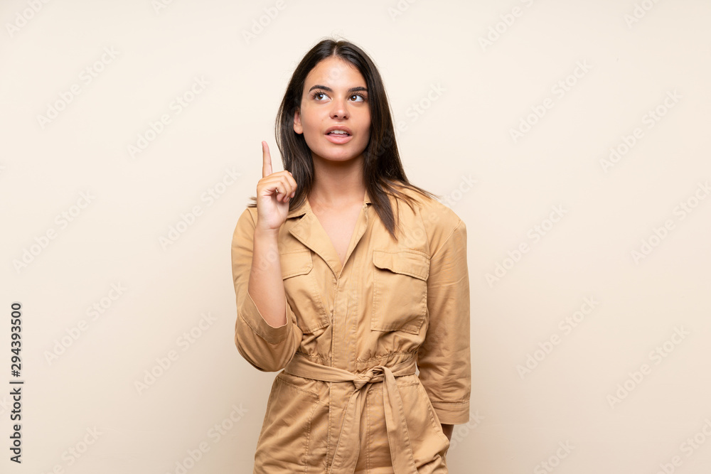 Young girl over isolated background thinking an idea pointing the finger up Young girl over isolated background thinking an idea pointing the finger up
