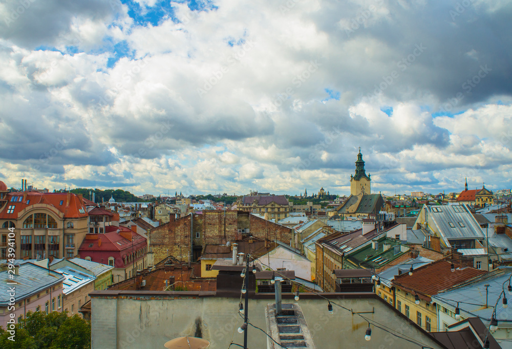 Naklejka premium Urban old architecture. Red multi-colored roofs of European houses and buildings in the center.